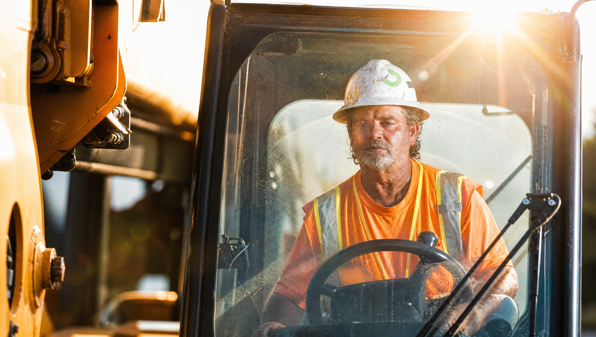 Texas construction foreman operating heavy machinery on a hot day